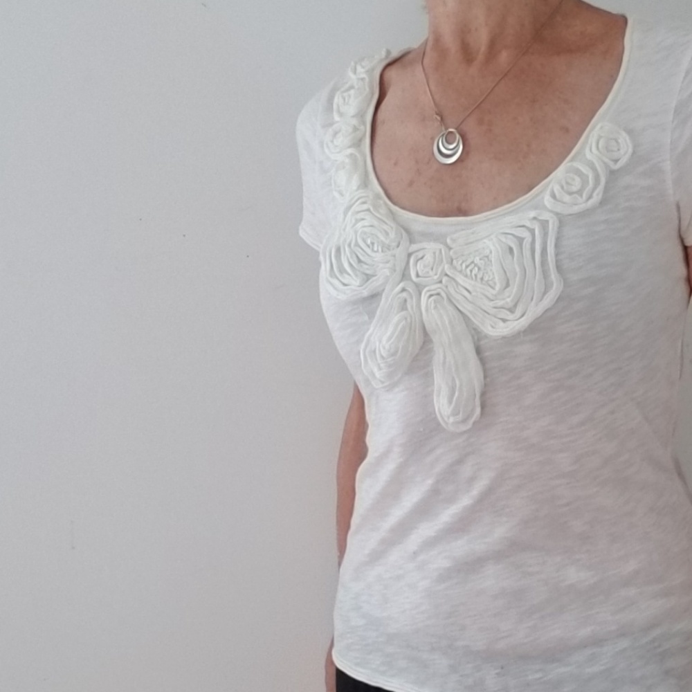 Press Ecru cap sleeve fabric flower decor top